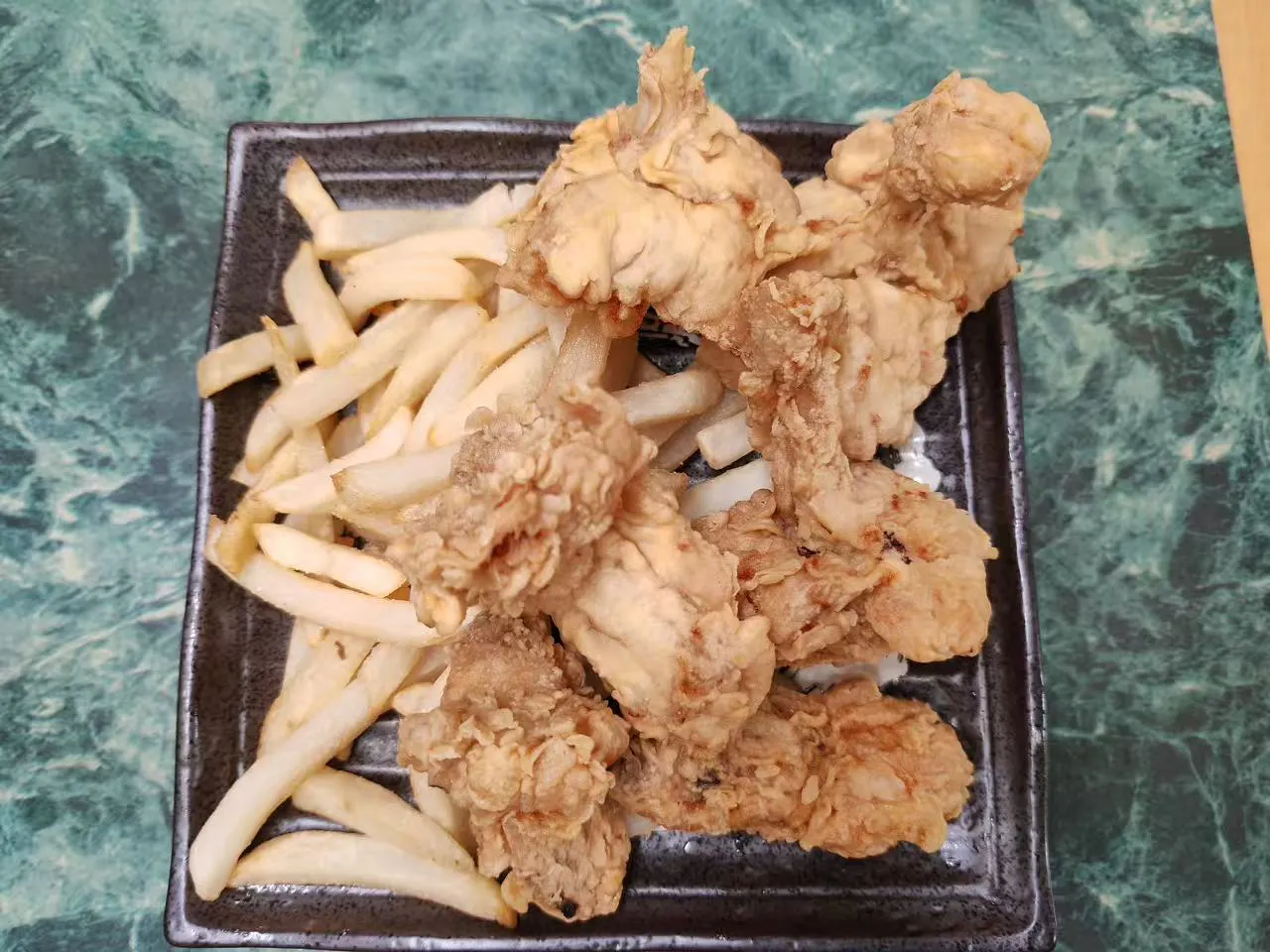 Crispy fried chicken pieces served with thick french fries at Asia Hibachi & Rice Bowls，an Asian Fusion Restaurant in Buffalo
